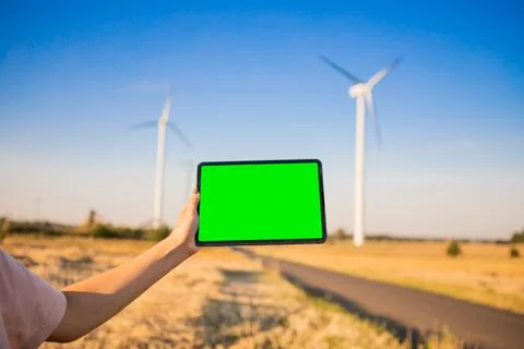 Green screen tablet on the windmills background. Chroma key. windmills green Stock Photos