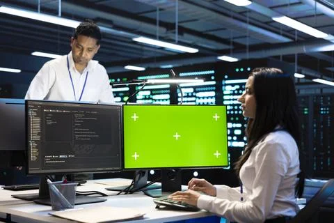 Green screen, teamwork and developers with computer work in data center Stockfoto's