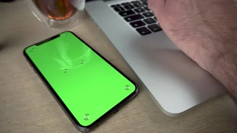 Green screen telephone next to working male Stock Footage 139444930