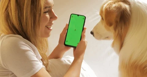GREEN SCREEN tracking dot. Portrait of Pretty girl student is using smartphone Stock Footage 121328163