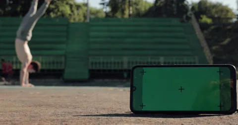 Green screen with tracking dots on phone and attractive fit man on background Stock Footage 144412488