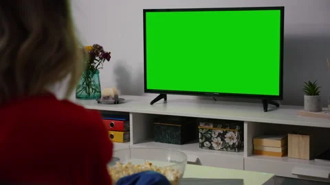Green Screen TV Close up. Shot behind model Shoulder watching Tv sitting on t 스톡 동영상 156344159