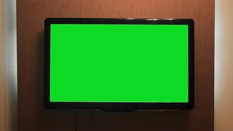 Green screen TV hanging on wall. Concept. Home TV with green screen on wall of Stock Footage