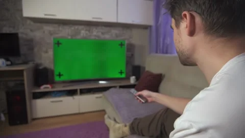 Green screen TV, man watching green screen TV Stock Footage 264100311