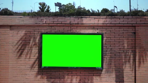 Green Screen TV Mounted On Brick Wall In Outdoor Urban Setting Stock Footage 318615763