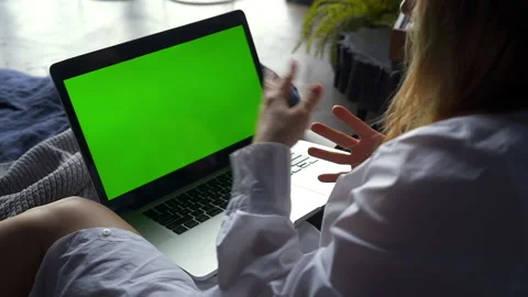 Green screen video call on computer, woman sit on bed and talk with gesture Stock Footage 154607302