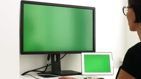 Green screen. Woman working at computer sitting at desk. View from back. Stock Footage 219791840