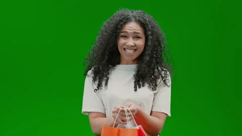 Green Screen young lady holding packets Stock Footage 232284499