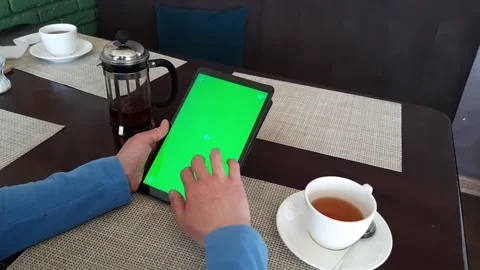 Green screened - track marked close up tablet pc is used by a woman hand Stock Footage 165597637