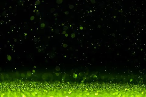 Green sequins fall on a black background Stock Photos