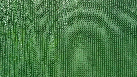 Green Shade Net Texture for Plants with Rain Drops Flowing Down Woven Mesh, Show Stock Footage 346156373