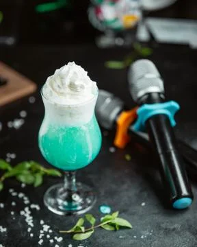 Green shake with cream on the table Stock Photos