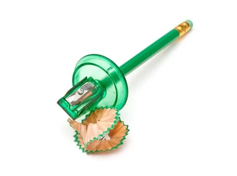 Green sharpener and pencil on white background. Stock Photos
