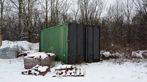 Green shipping container in winter snowfall Stock Footage