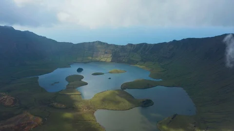 Green slopes of caldera of extinct stratovolcano Caldeirao do Corvo. Aerial of Stock Footage 117306009