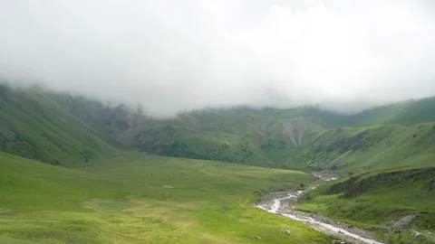 Green slopes, river and clouds Stock Footage 342713269