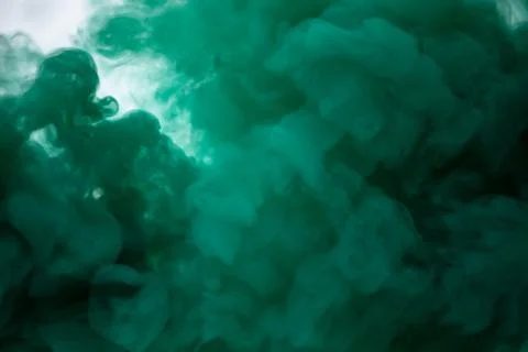 Green smoke bomb exploding against white background Stock Photos