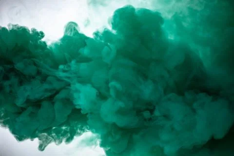 Green smoke bomb exploding against white background Foto stock
