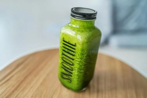 Green smoothie detox healthy breakfast to go drink celery juice diet bottle with Stock Photos