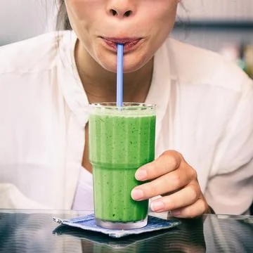 Green smoothie drink healthy detox diet woman drinking matcha tea cold juice Stock Photos