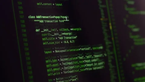 Green source code displayed on monitor during vibe coding supported by ai Stock Footage 345652636