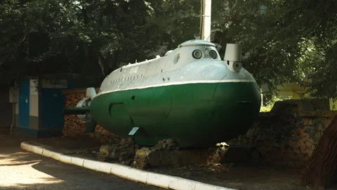 A green Soviet submarine stands in the middle of the street. Wartime era. W.. Stock-Footage 346329058
