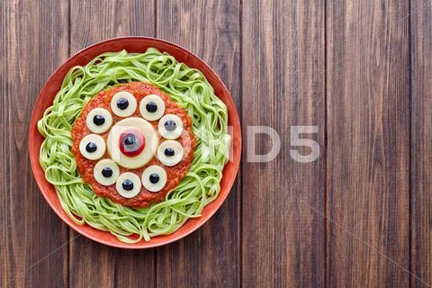 Green spaghetti creative pasta scary halloween food monster meal Stock Photos