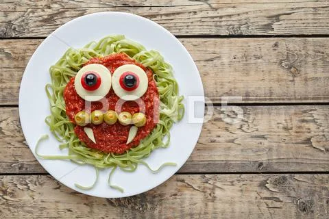 Green spaghetti pasta creative spooky halloween vegetarian food vampire monster Stock Photos
