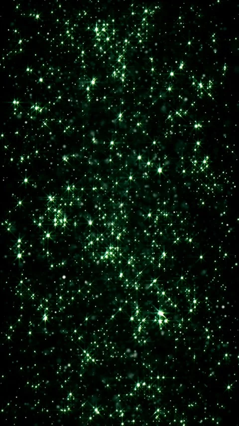 Green sparkles dance in the dark, creating a mesmerizing abstract scene Stock Footage 315906323