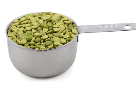 Green split peas in a measuring cup Stock Photos