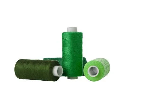 Green spool of sewing thread isolated on white background Stock Photos