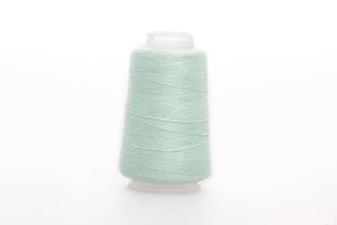 Green spool of thread isolated on white background. Skein of woolen threads Stock Photos