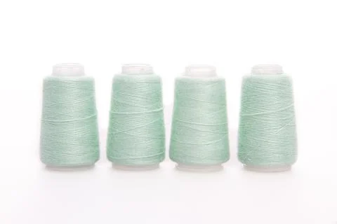 Green spool of thread isolated on white background. Skein of woolen threads Stock Photos