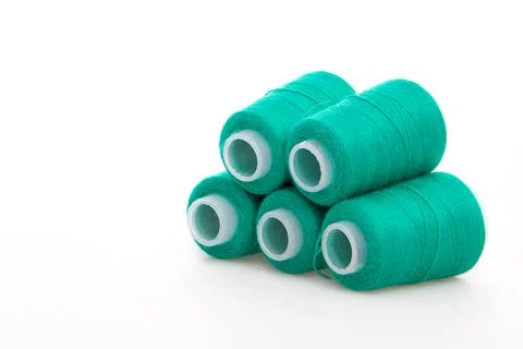 Green spool of thread isolated on white background. Skein of woolen threads Stock Photos