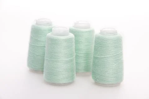 Green spool of thread isolated on white background. Skein of woolen threads Stock Photos