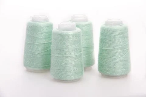 Green spool of thread isolated on white background. Skein of woolen threads Stock Photos