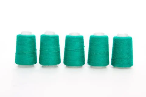 Green spool of thread isolated on white background. Skein of woolen threads Stock Photos