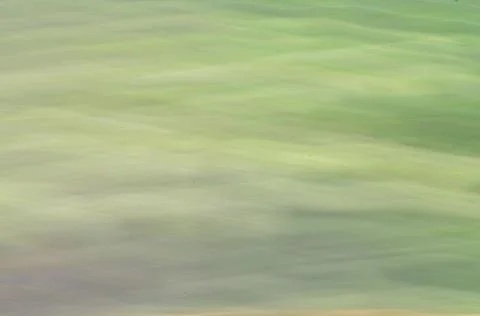Green, spring, hilly terrestrial surface, shot from a height at high speed. Stock Photos