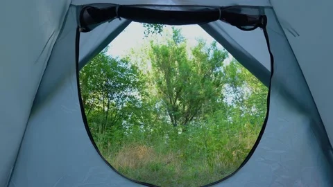 Green spring or summer landscape seen through entrance of blue camping tent Vidéo 166947534