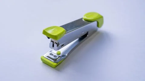 Green stapler on a white background Stock Photos