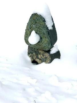 Green statue under the snow hat Foto stock
