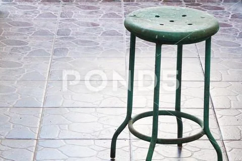 Green Steel and Wood Traditional Bench on the tropical vintage stone flooring Stock Photos