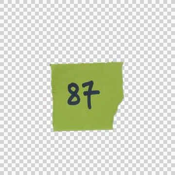 Green sticky note with the number eighty seven written in dark ink Фото