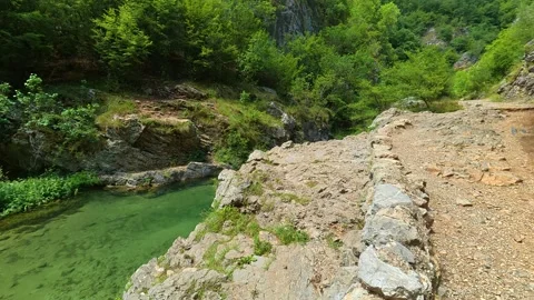 Green stream flows gently through rocky terrain. Gradasnica River Canyon, Serbia Stock Footage 342320274