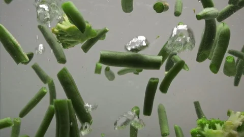 Green string beans and broccoli in boiling water. Stock Footage 124520460
