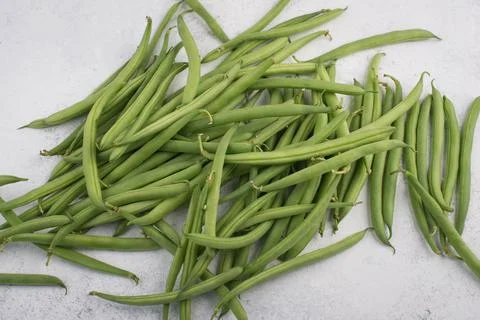 Green string beans on a  textured background, empty space for text, vegetable Stock Photos
