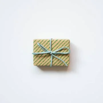Green stripe pattern brown gift box isolated on white background. top view... Stock Photos