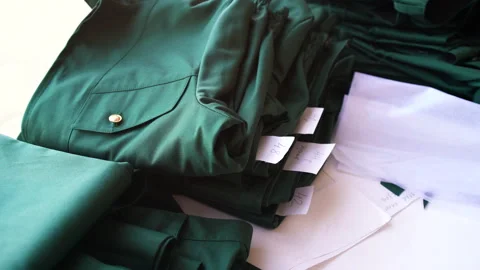 Green suits of the same type in different sizes. There are handmade things on Stock Footage 156662658