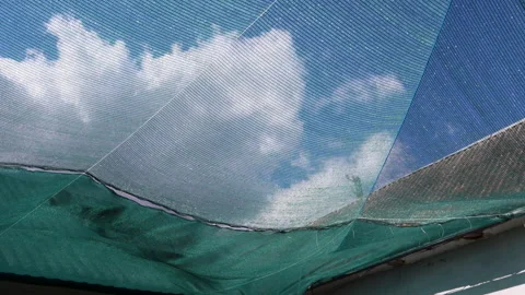 Green sunshade netting blowing in wind Stock Footage 338349565