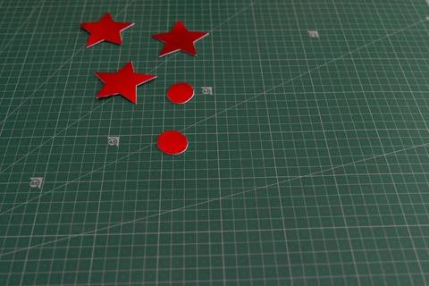 A green surface with one red star and three red stars. Graphic resources Stock Photos